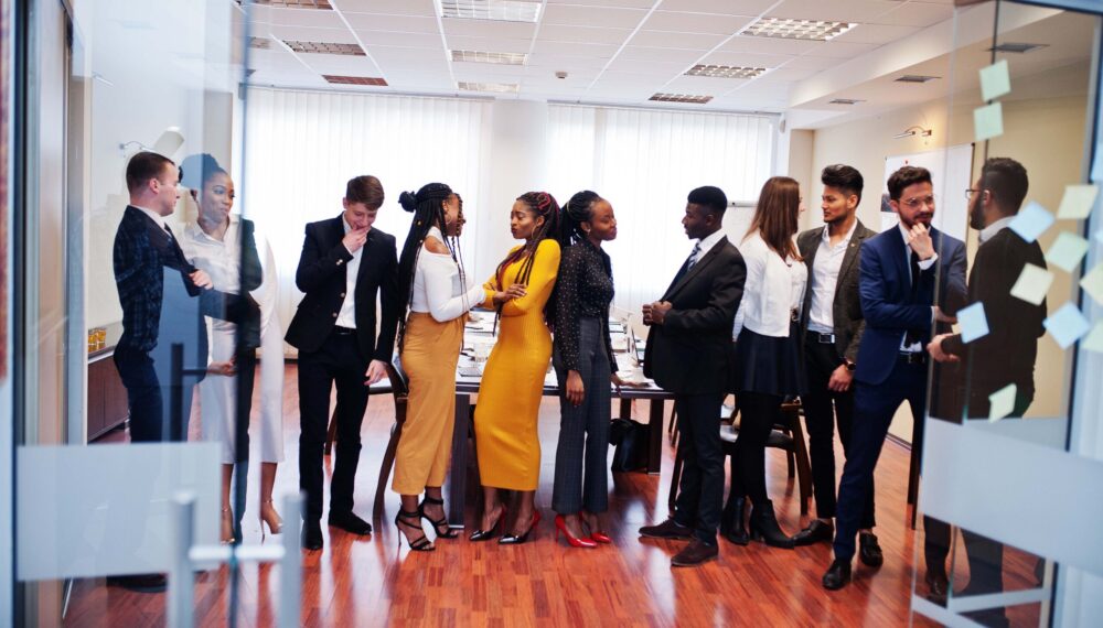 Large group of eleven multiracial business people standing at office. Diverse group of employees in formal wear.