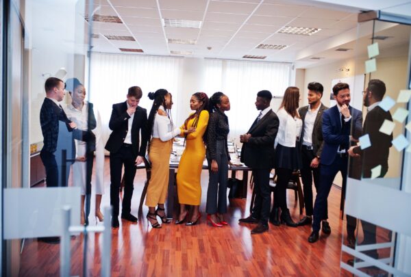 Large group of eleven multiracial business people standing at office. Diverse group of employees in formal wear.